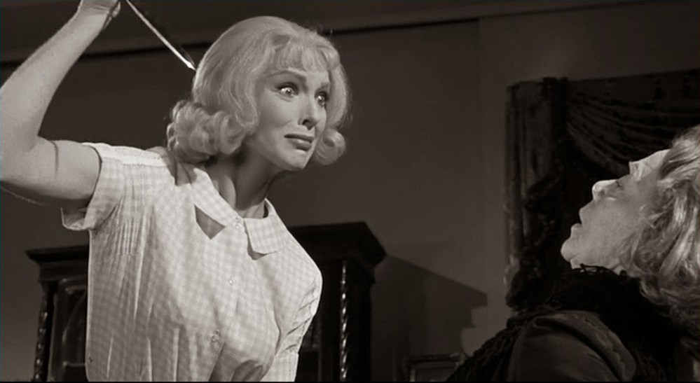 Emily (Arless) threatens her helpless charge Helga (Leontovich).